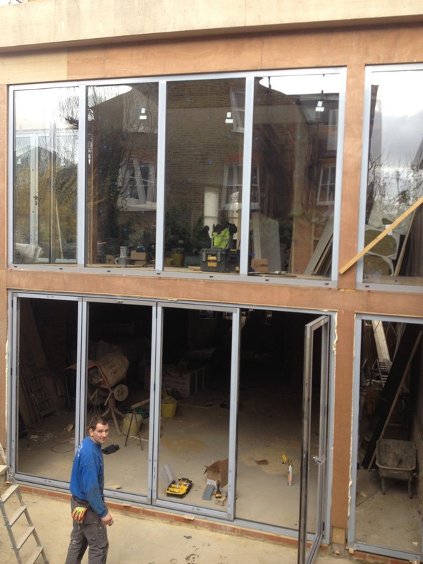 Aluminium bi-fold doors with two-storey glazing in Forest Gate