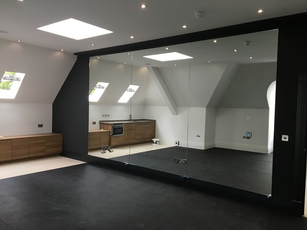 Frameless glass wall dividing loft conversion in Forest Gate