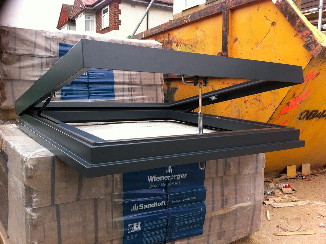 Opening flat roof skylight in anthracite grey installed in Forest Gate