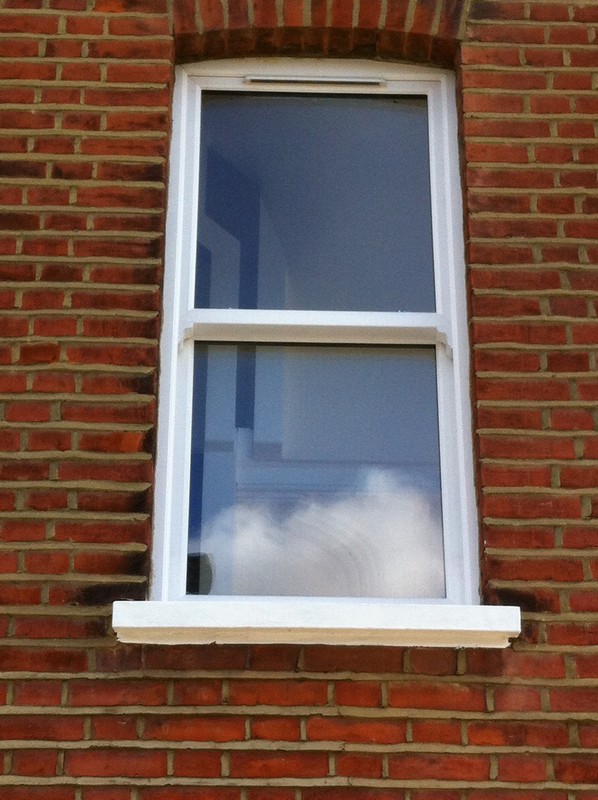 uPVC sash window on Victorian red brick house in Forest Gate